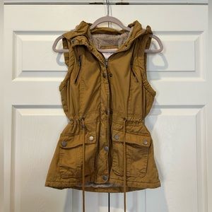 Mustard yellow cargo vest.